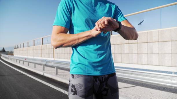 istock young fit man jogging outdoors, exhausted taking a rest on a empty street 1200698398