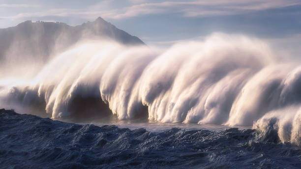 big wave breaking with spray stock photo