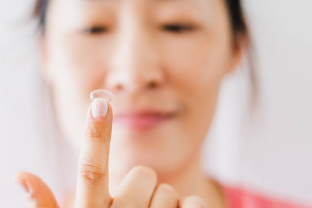 istock Beautiful Woman Putting Eye Lenses With Hands 1200700571