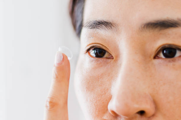 istock Beautiful Woman Putting Eye Lenses With Hands 1200700683