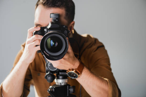 istock selective focus of photographer taking photo with digital camera on backstage 1200700874