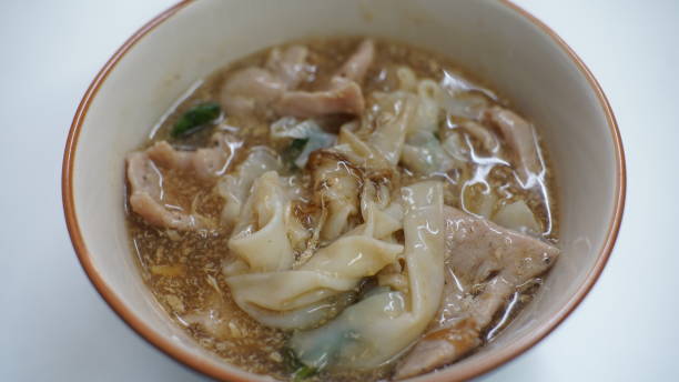istock noodles in gravy pork, fried eggs and vegetables 1200701364