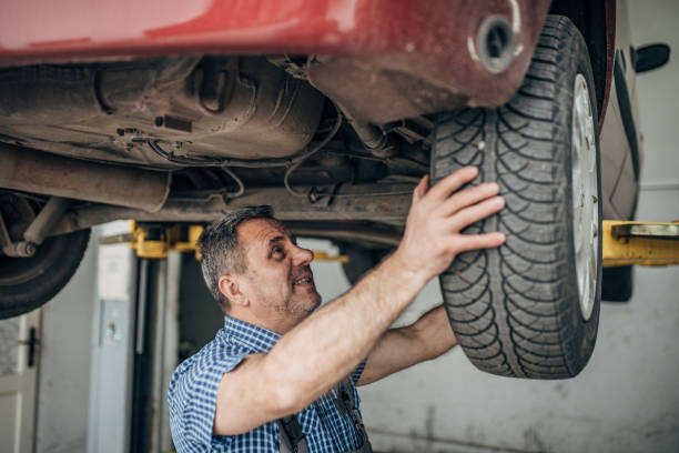 istock Auto mechanic repairing car at service, tire replacement 1200702333