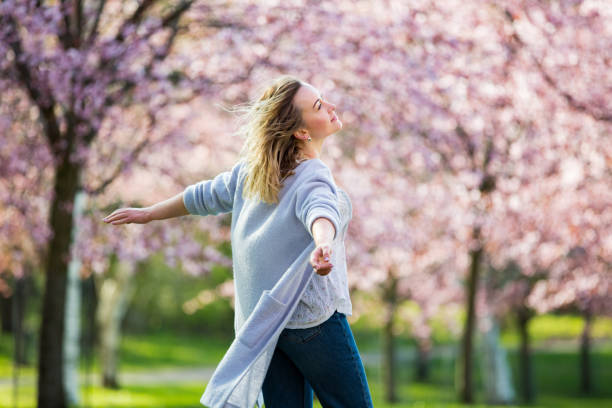 istock Dancing, running and whirling in beautiful park with cherry trees in bloom 1200703726
