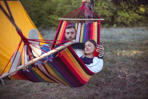 istock Romantic hipster couple enjoy rest on a hammock 1200705204