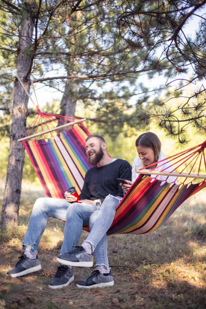 istock Romantic hipster couple enjoy rest on a hammock 1200705490