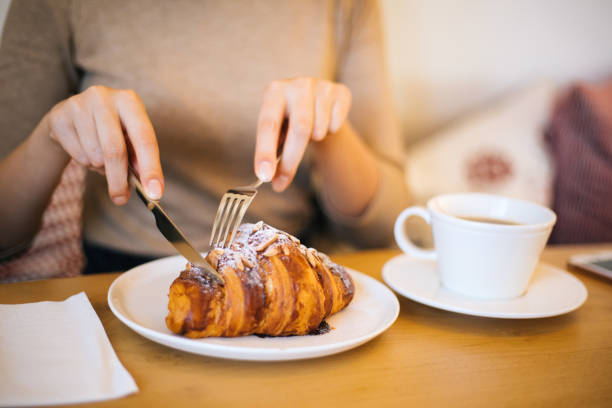 Woman eating croissant