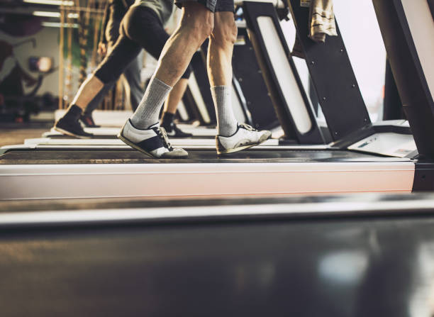 istock Unrecognizable man exercising on treadmill in a gym. 1200706396