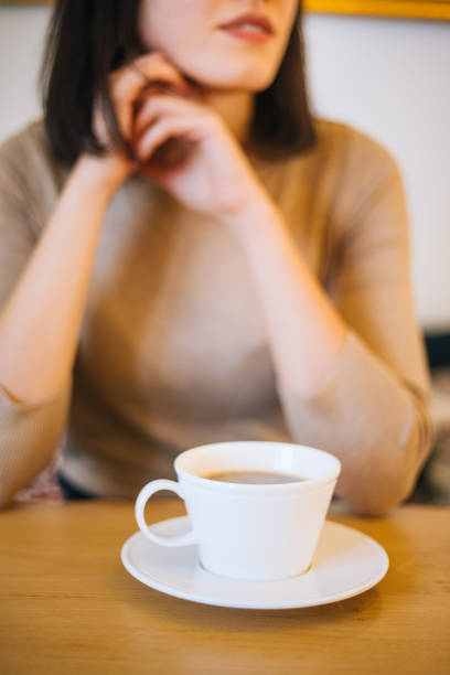 istock Woman drinking coffee at cafe 1200706499