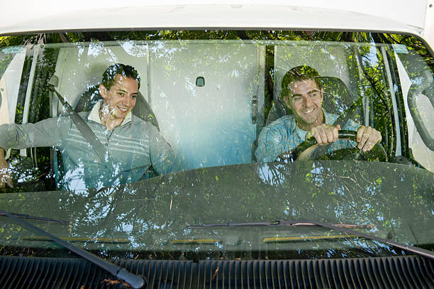 view through windshield of 2 men drivng truck - drivng zdjęcia i obrazy z banku zdjęć