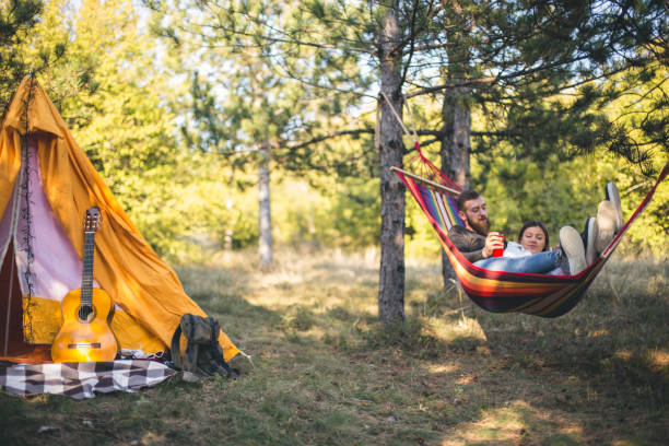 istock Romantic hipster couple enjoy rest on a hammock 1200706619