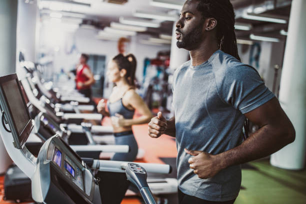 istock Young black athlete running on treadmill in a gym. 1200706841
