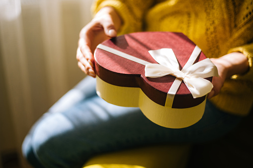 Young woman holding valentine day gift box