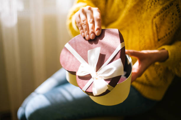 istock Young woman holding valentine day gift box 1200707188