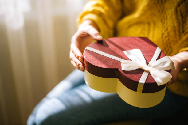 istock Young woman holding valentine day gift box 1200707228