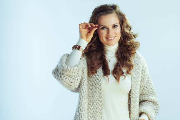 istock happy woman plucking eyebrows on winter light blue background 1200708839