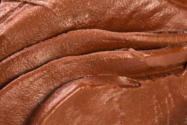 Chocolate flowing, macro shot with delicious heated chocolate.