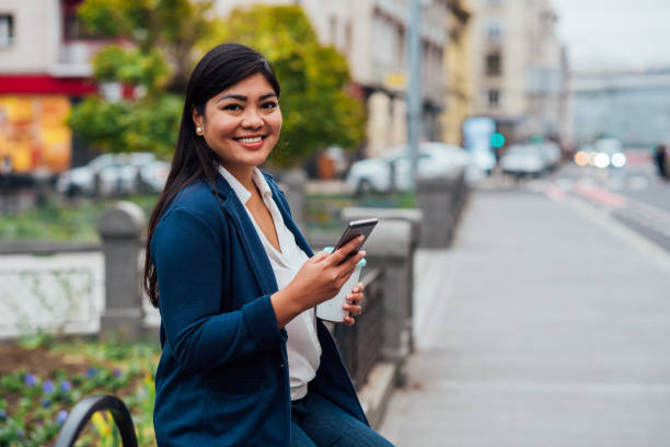 istock Asian businesswoman on a coffee break using smartphone 1200709897