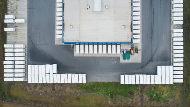 istock Loading bay, distribution logistics building, parking lot - aerial view 1200710407