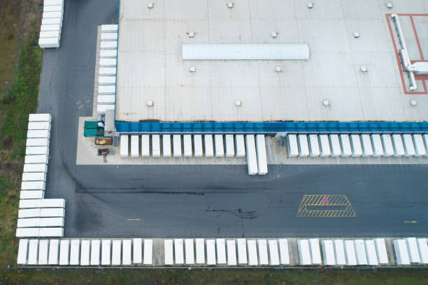 istock Loading bay, distribution logistics building, parking lot - aerial view 1200710529