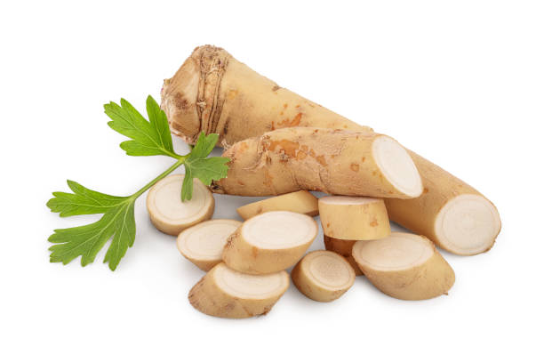 istock Horseradish root with slices and parsley isolated on white background 1200710756