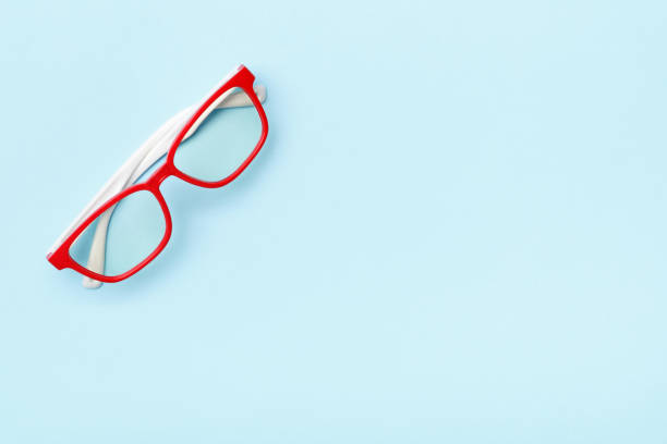 istock Modern trendy glasses in red frames on a blue background. Copy space 1200711977