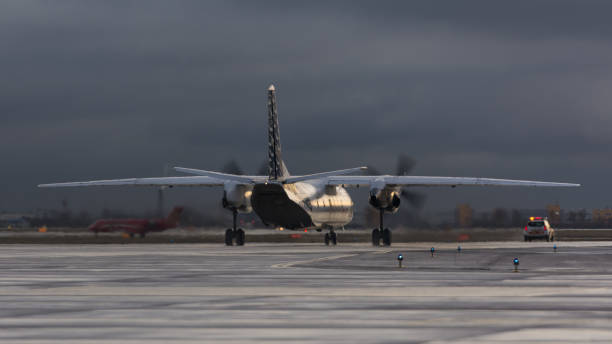 RAF-Avia Antonov An-26B RAF-Avia Antonov An-26B, YL-RAD, following Follow-me car to the stand. Pulkovo International Airport. Saint-Petersburg, Russia. 13 January 2020. antonov an 26 stock pictures, royalty-free photos & images