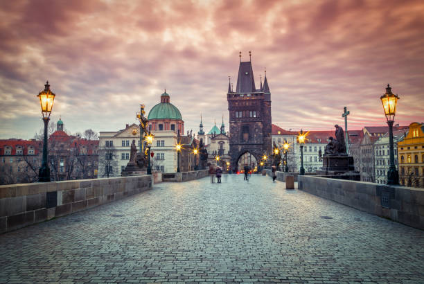 istock Charles Bridge with lit lamps in the early morning. 1200713558
