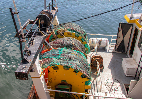 Shooting of fishing nets wound on drums ready for departure, at 18/135, 200 iso, f 13, 1/160 second