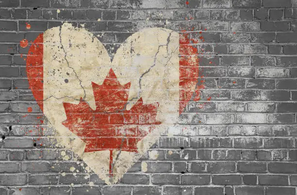 Photo of Heart shaped flag of Canada, painted on brick wall