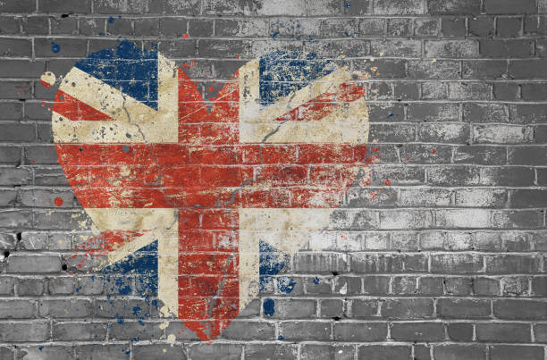 Heart shaped flag of Britain painted on brick wall Grunge distressed heqart shaped flag of Britain painted on old weathered grey brick wall british flag photos stock pictures, royalty-free photos & images