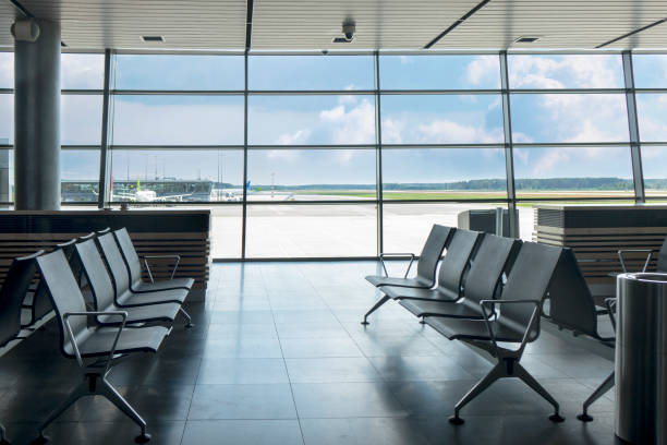 istock Empty chairs at waiting area in the airport terminal. 1200714911