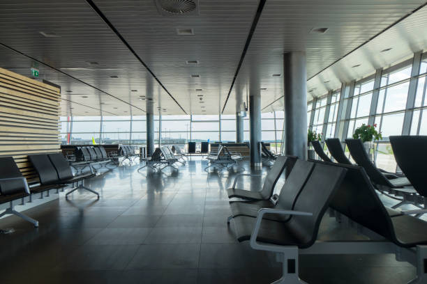 istock Airport terminal with empty chairs for waiting departure. 1200714925