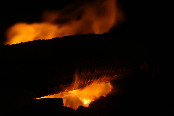 Corn being cooked on coal near beach with some fire spark . A corn roaster sparkling fire in the shores of Marina Beach, Chennai, India on night