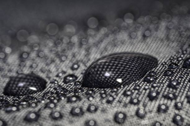 istock Close-up view on water drop on waterproof impregnated umbrella fabric. 1200715411