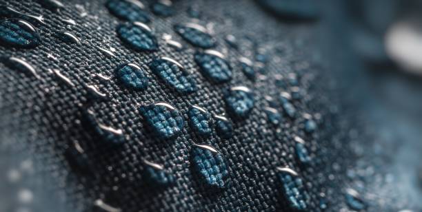 istock Close-up view on water drops on waterproof impregnated fabric in rain. 1200715449