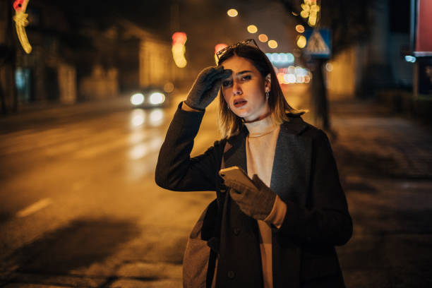 istock Woman looking for taxi 1200715646