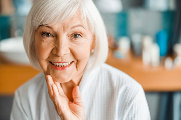istock Lovely old woman looking at camera and smiling 1200716563