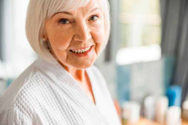 istock Joyful elderly woman looking at camera and smiling 1200716587