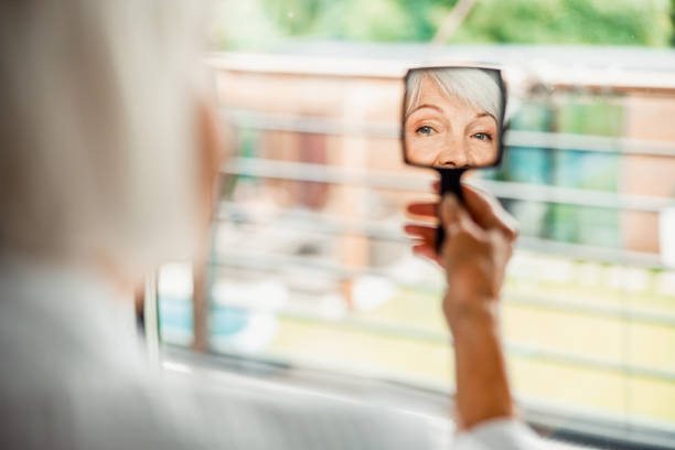 istock Senior woman looking in small hand mirror 1200716589