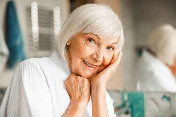 istock Cheerful elderly woman propping up head on hand 1200716595