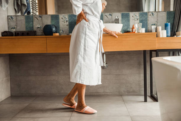 istock Elderly woman in bathrobe feeling pain in back 1200716654