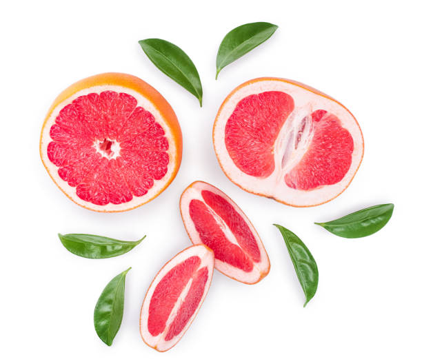 istock Grapefruit and slices with leaves isolated on white background. Top view. Flat lay 1200717096
