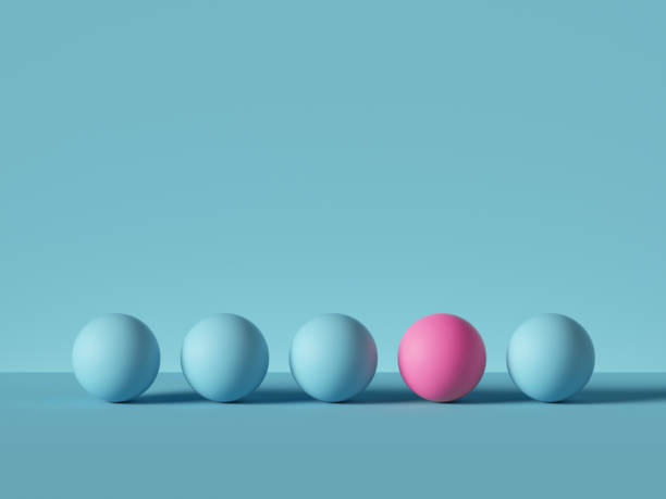 istock 3d render, abstract primitive geometric shapes isolated on blue background. Pink ball, row of blue balls. Outstanding idea, one of a kind metaphor. Modern minimal design 1200717650