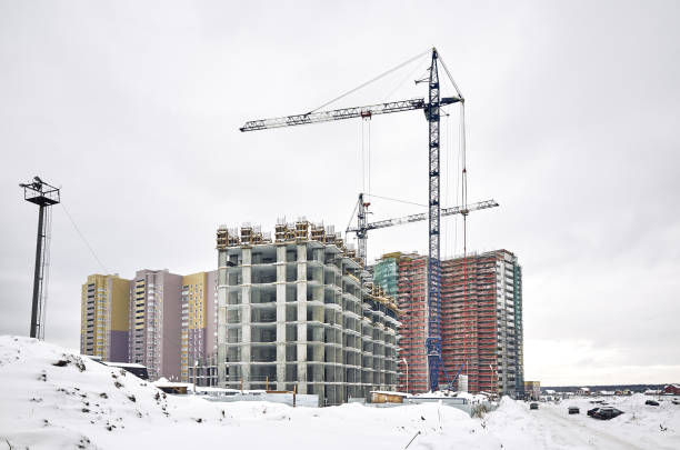 istock Construction site, new building and crane, gray sky 1200719067