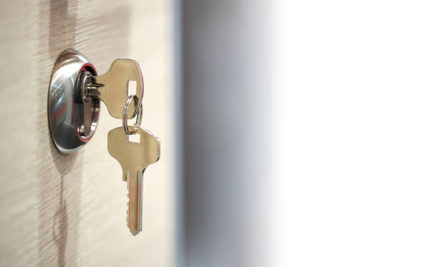 istock keys in the keyhole with white text field 1200719993