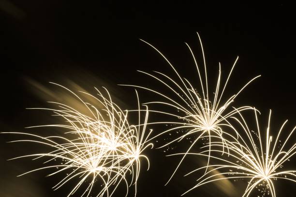 istock Luxury fireworks event sky show with beautiful fine yellow stars 1200720351