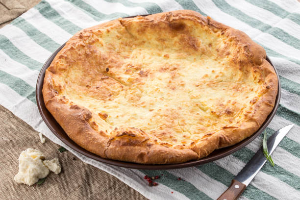 istock Georgian cheese bread khachapuri imeruli on round plate on tablecloth 1200721643