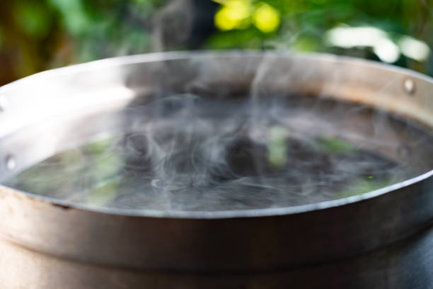 istock Boiling water with steam on black background 1200721938