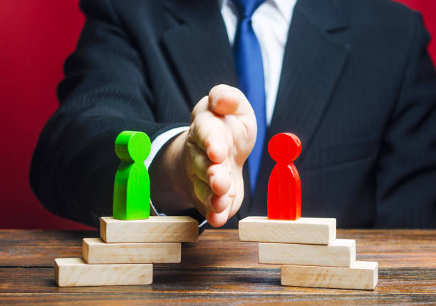 istock Man divides conflicting sides parties with a hand. Mediator services. Stop fight, ceasefire clashes, hot phase of war. Finding a compromise. Avoidance violence, bullying. protection of witnesses. 1200723534